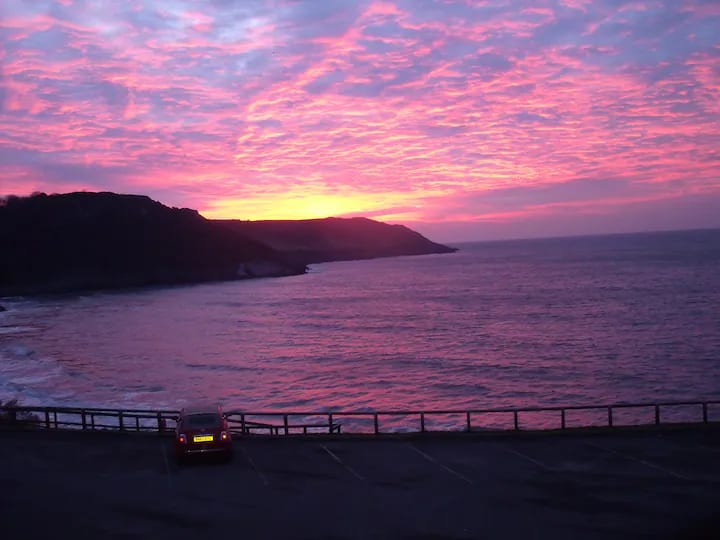 Red skies over Caswell Bay at sunset